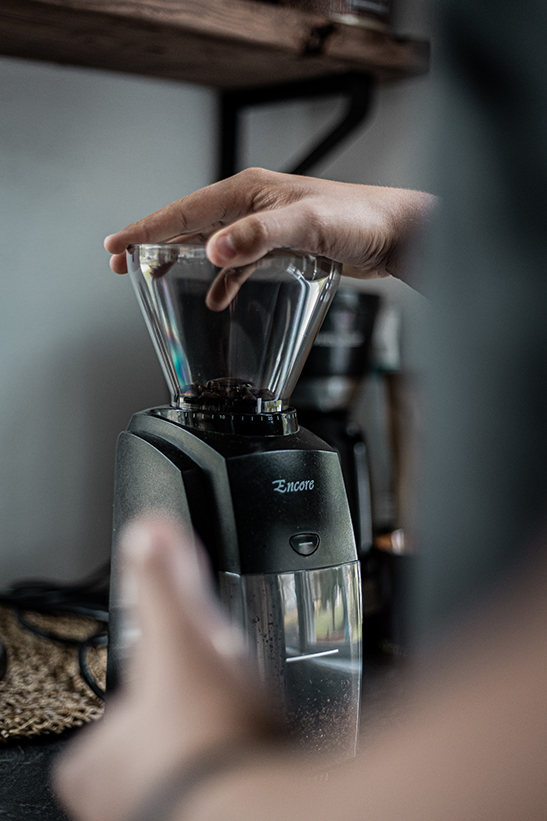a barista grinding coffee beans