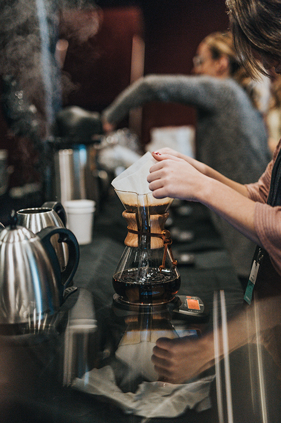 a barista making a filter coffee using a chemex