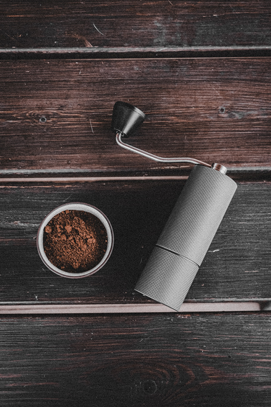 a coffee grinder with ground coffee
