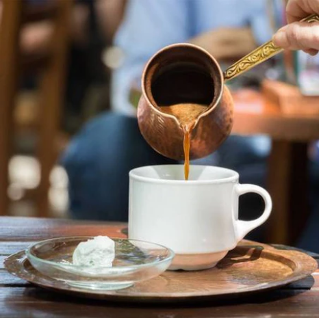 a turkish coffee poured from a cezve