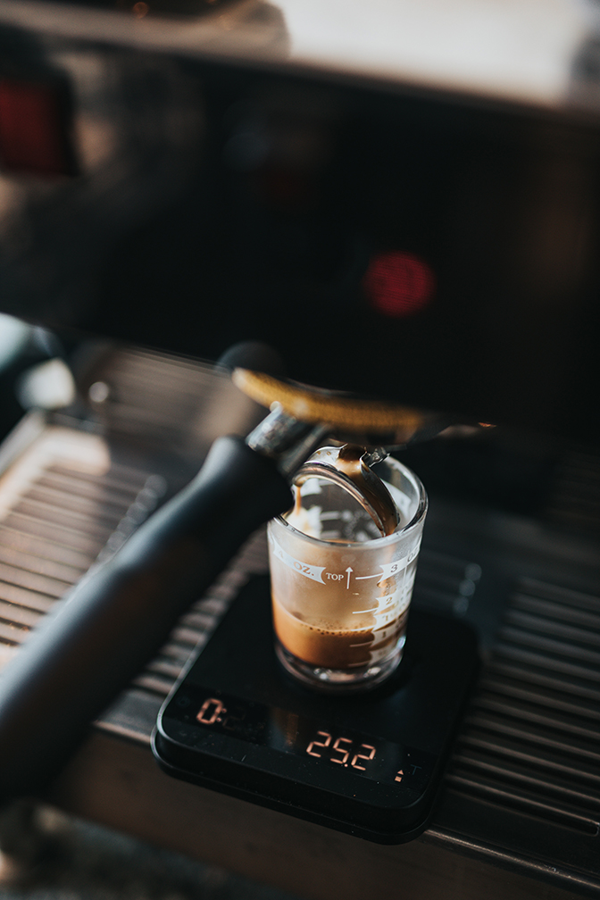 an espresso being prepared on a commerical espresso machine