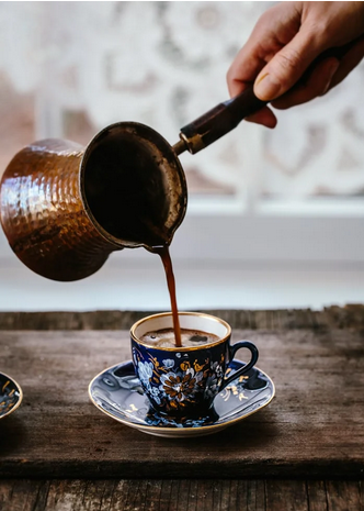 pouring a turkish coffee in a cezve